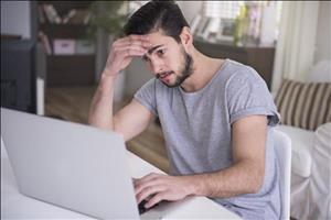 5cc2e717-7517-40b1-b7fa-5d55e9599af3-tired-young-man-working-home-with-his-laptop.jpg